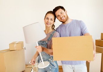 Image showing couple with boxes and lamp moving to new home