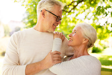 Image showing happy senior couple hugging at summer park