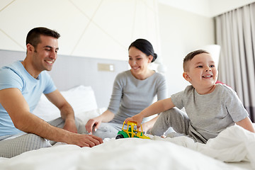 Image showing happy family in bed at home or hotel room