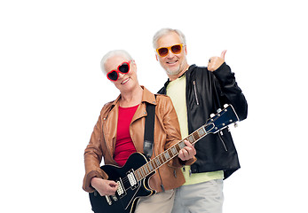 Image showing happy senior couple with guitar showing thumbs up