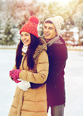 Image showing happy couple ice skating on rink outdoors