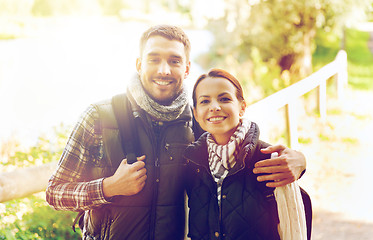 Image showing happy couple with backpacks hiking and hugging