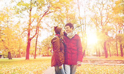 Image showing happy young couple walking in autumn park