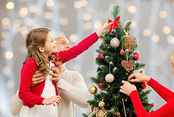 Image showing mother, father and daughter at christmas tree