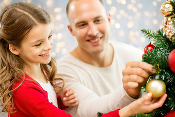 Image showing father and daughter decorating christmas tree