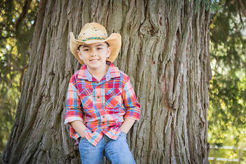 Image showing Mixed Race Young Boy Wearing Cowboy Hat Standing Outdoors.