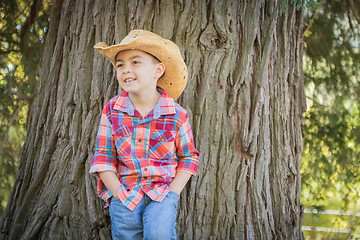 Image showing Mixed Race Young Boy Wearing Cowboy Hat Standing Outdoors.