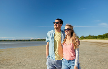 Image showing happy couple hugging on summer beach