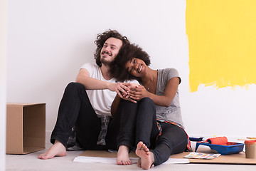 Image showing young multiethnic couple relaxing after painting