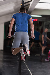 Image showing man doing exercises parallel bars