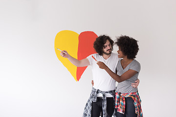 Image showing couple with painted heart on wall