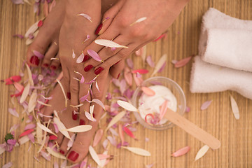 Image showing female feet and hands at spa salon