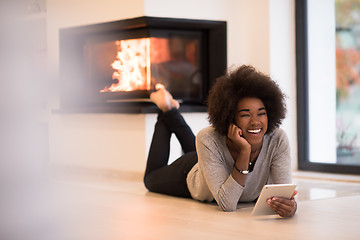 Image showing black women using tablet computer on the floor