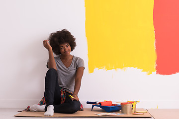 Image showing back female painter sitting on floor