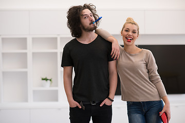 Image showing couple in party hats blowing in whistle