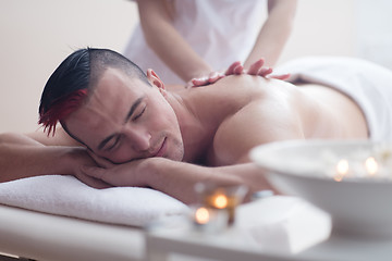 Image showing young man having a back massage