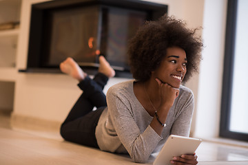 Image showing black women using tablet computer on the floor