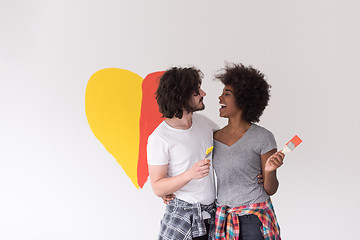 Image showing couple with painted heart on wall