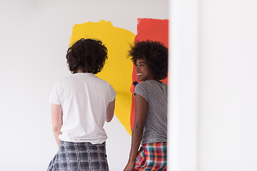 Image showing multiethnic couple painting interior wall