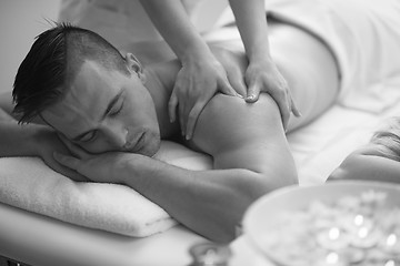 Image showing young man having a back massage