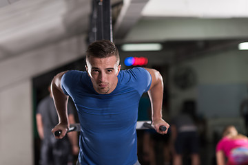 Image showing man doing exercises parallel bars