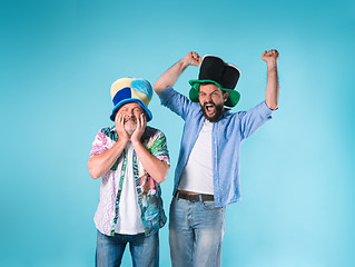 Image showing The two football fans over blue