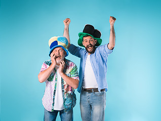 Image showing The two football fans over blue