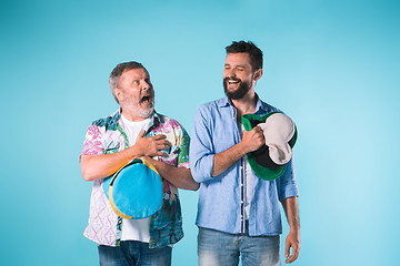 Image showing The two football fans singing the national anthem over blue