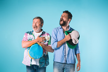 Image showing The two football fans singing the national anthem over blue