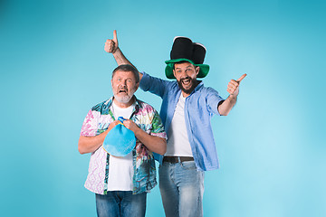 Image showing The two football fans over blue