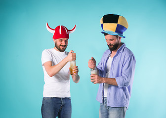 Image showing Two Excited Male Friends Celebrate Watching Sports