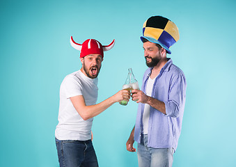 Image showing Two Excited Male Friends Celebrate Watching Sports