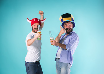 Image showing Two Excited Male Friends Celebrate Watching Sports