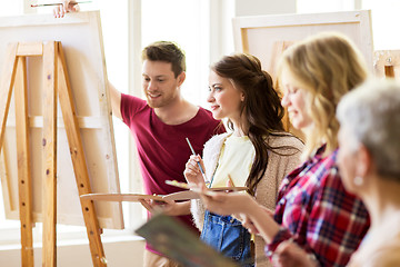 Image showing group of young artists painting at art school