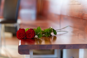 Image showing red roses on bench at funeral in church