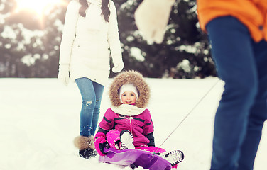 Image showing happy family with sled walking in winter forest
