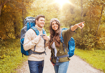 Image showing smiling couple with backpacks hiking