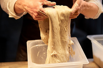 Image showing close up of baker hands making bread dough