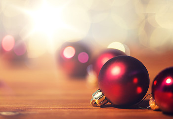 Image showing close up of red christmas balls on wood