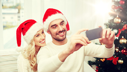 Image showing couple taking selfie with smartphone at christmas