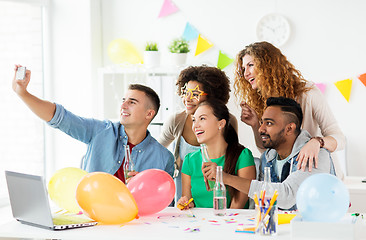 Image showing happy team taking selfie at office party