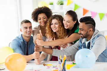 Image showing happy team at office party showing thumbs up