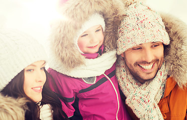 Image showing happy family with child in winter clothes outdoors