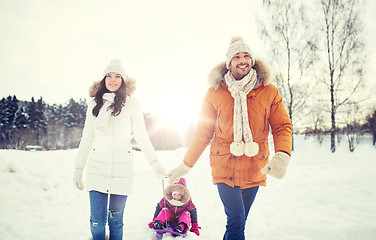 Image showing happy family with sled walking in winter outdoors