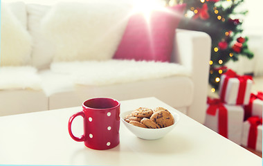 Image showing close up of christmas cookies and red cup on table