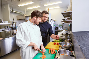 Image showing chef and cook cooking food at restaurant kitchen