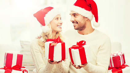 Image showing happy couple at home exchanging christmas gifts