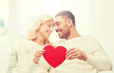 Image showing happy couple with red heart hugging at home