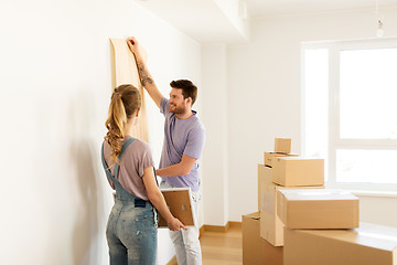 Image showing happy couple with boxes moving to new home