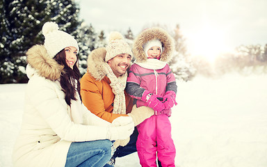 Image showing happy family with child in winter clothes outdoors